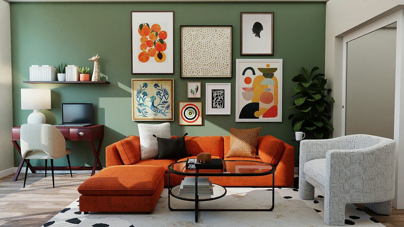 Living room with a sage green wall, a coral sofa and a gallery of prints